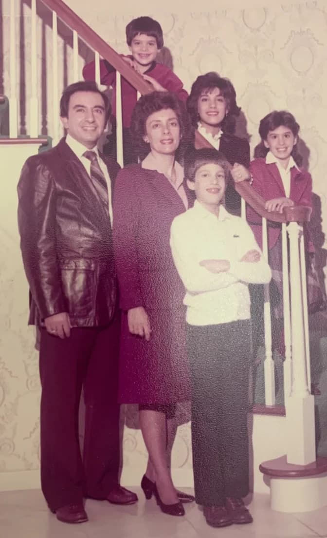 A 1980s family portrait on a staircase, faded to a heavy magenta cast